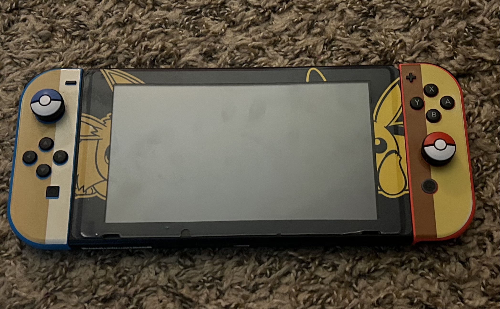 Switch with Pikachu and Eevee Colors on the Side Controller